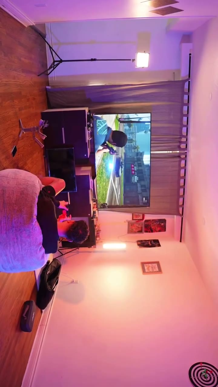 Creative gaming setup bathed in purple and pink light